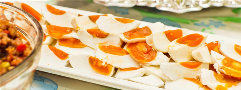 A Plate of Halved Salted Duck Eggs as a Tradtional Congee Accompaniment