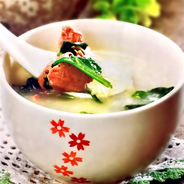 Chinese Pork Liver Congee With Spinach In Bowl